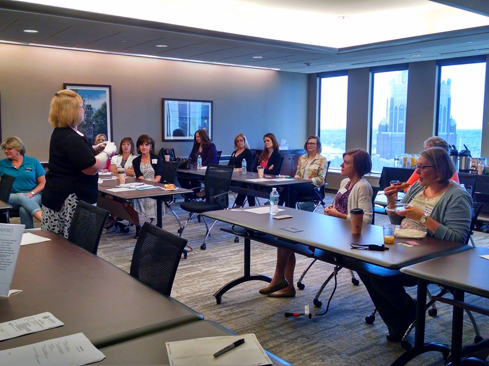 NAWBO Iowa members and guests learning from a speaker at a Lunch Hour Program