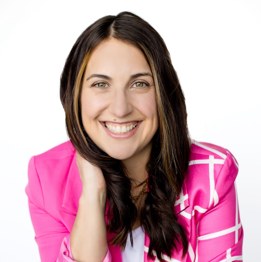 dark haired woman, smiling wearing a pink blazer