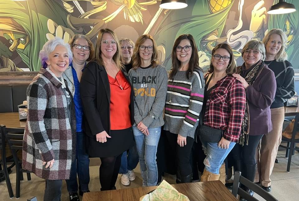 NAWBO Iowa members and guests posting for a picture at a Women, Wine & Wisdom event